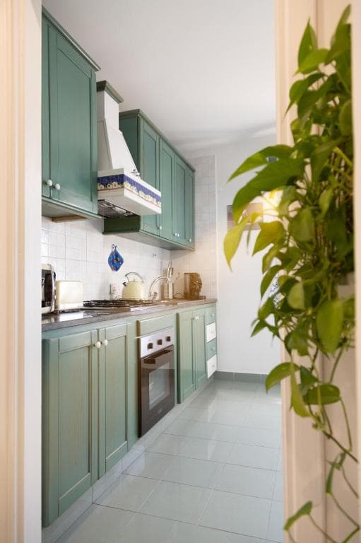 Private kitchen with green cabinets and oven at Casa Petito