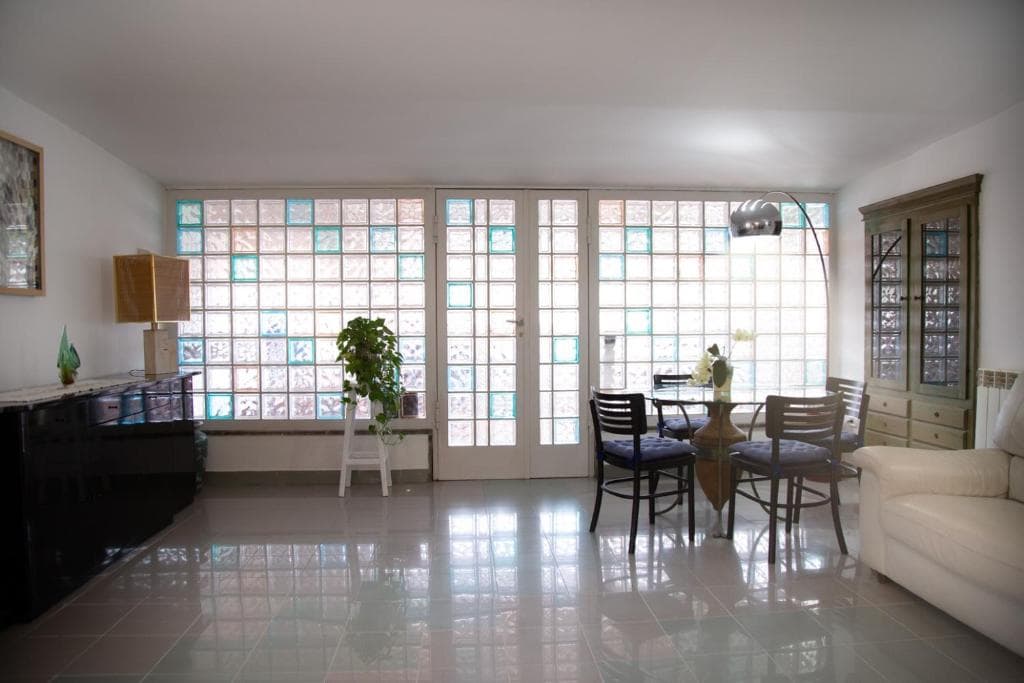 Bright living room with glass feature wall at Casa Petito